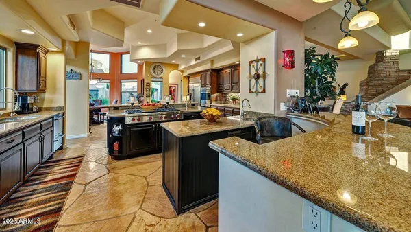 a kitchen with stainless steel appliances kitchen island granite countertop a sink and cabinets