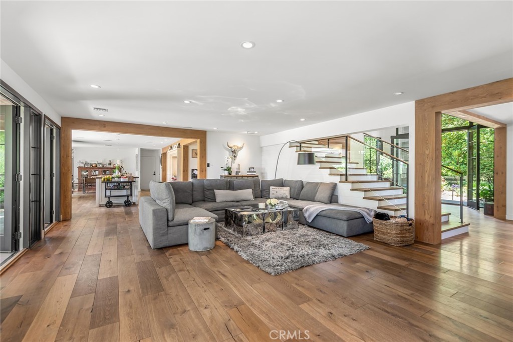 5207 Saddle Creek Road Hidden Hills, CA 91302 - Photo 15 of 54 a living room with furniture wooden floor and large windows