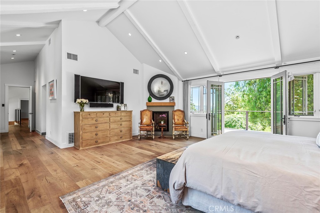 5207 Saddle Creek Road Hidden Hills, CA 91302 - Photo 22 of 54 a spacious bedroom with a bed and a flat screen tv
