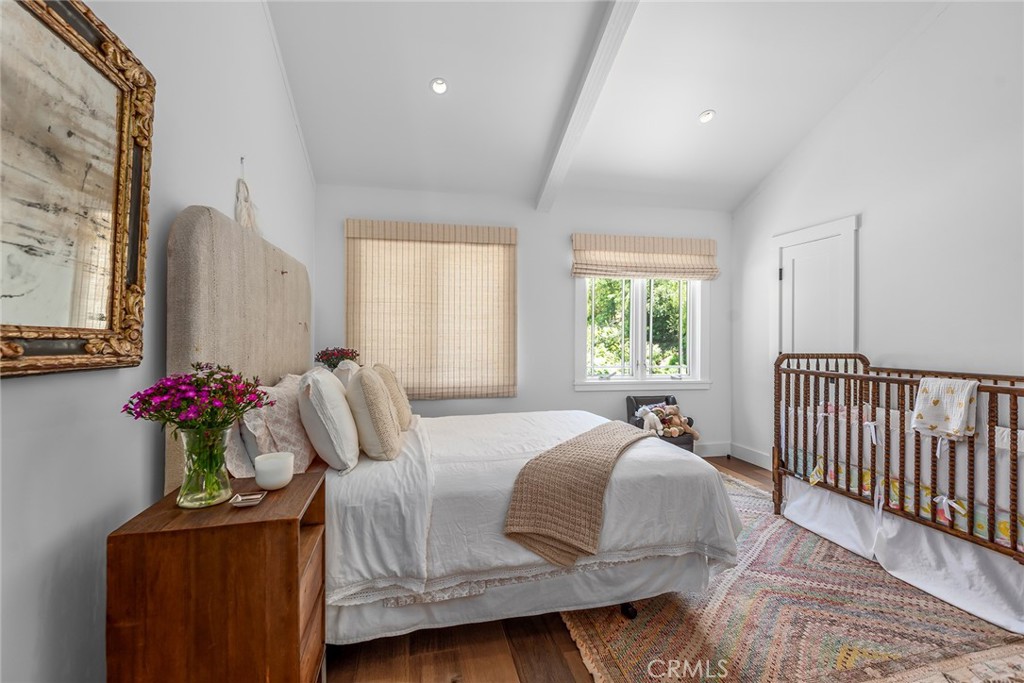 5207 Saddle Creek Road Hidden Hills, CA 91302 - Photo 30 of 54 a bedroom with a bed and wooden floor