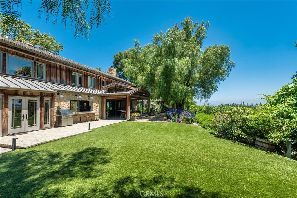 5207 Saddle Creek Road Hidden Hills, CA 91302 - Photo 35 of 54 a front view of a house with a garden