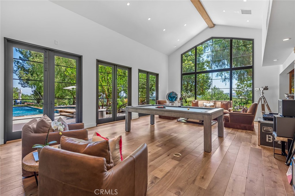 5207 Saddle Creek Road Hidden Hills, CA 91302 - Photo 5 of 54 a living room with furniture and a large window