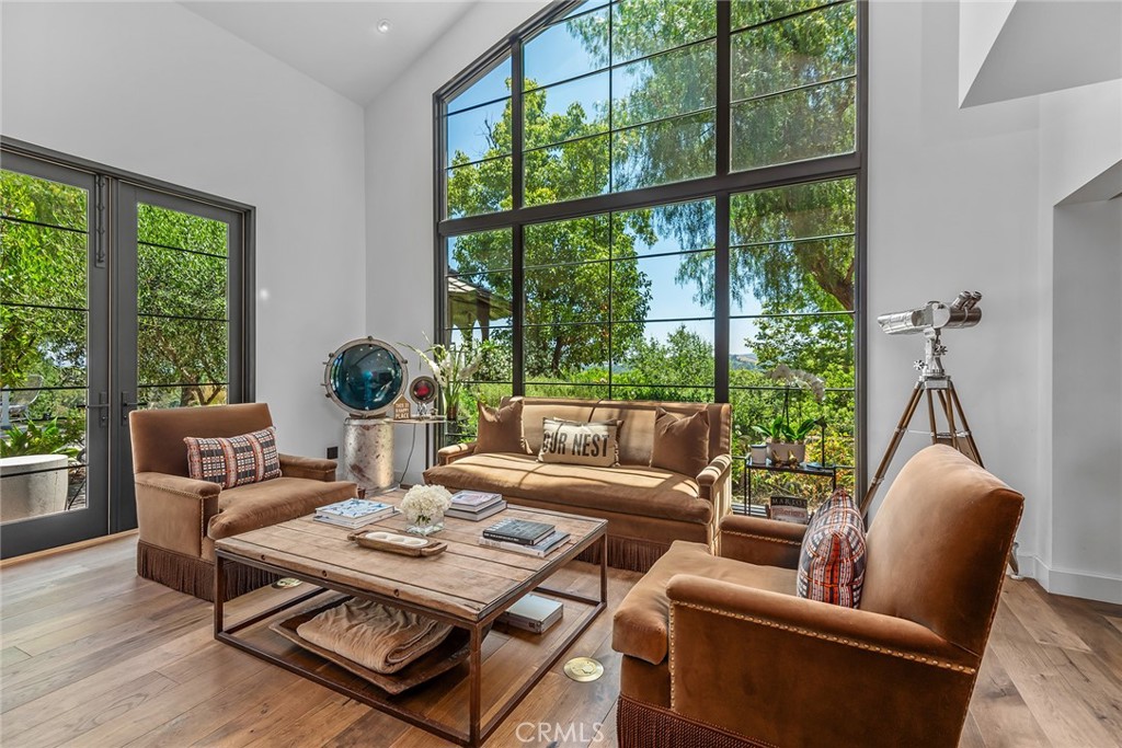 5207 Saddle Creek Road Hidden Hills, CA 91302 - Photo 7 of 54 a living room with furniture a table and a potted plant