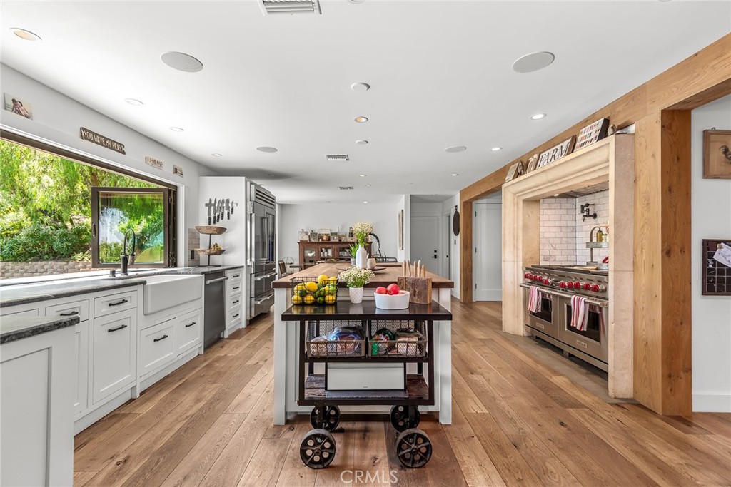 5207 Saddle Creek Road Hidden Hills, CA 91302 - Photo 10 of 54 a bedroom with furniture and a wooden floor