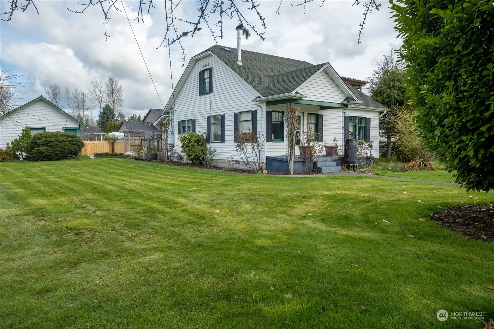 1810 Collins Road Buckley, WA 98321 - Photo 3 of 25 a front view of a house with a garden and trees