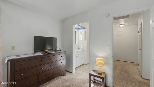 a bathroom with a toilet a sink and a mirror