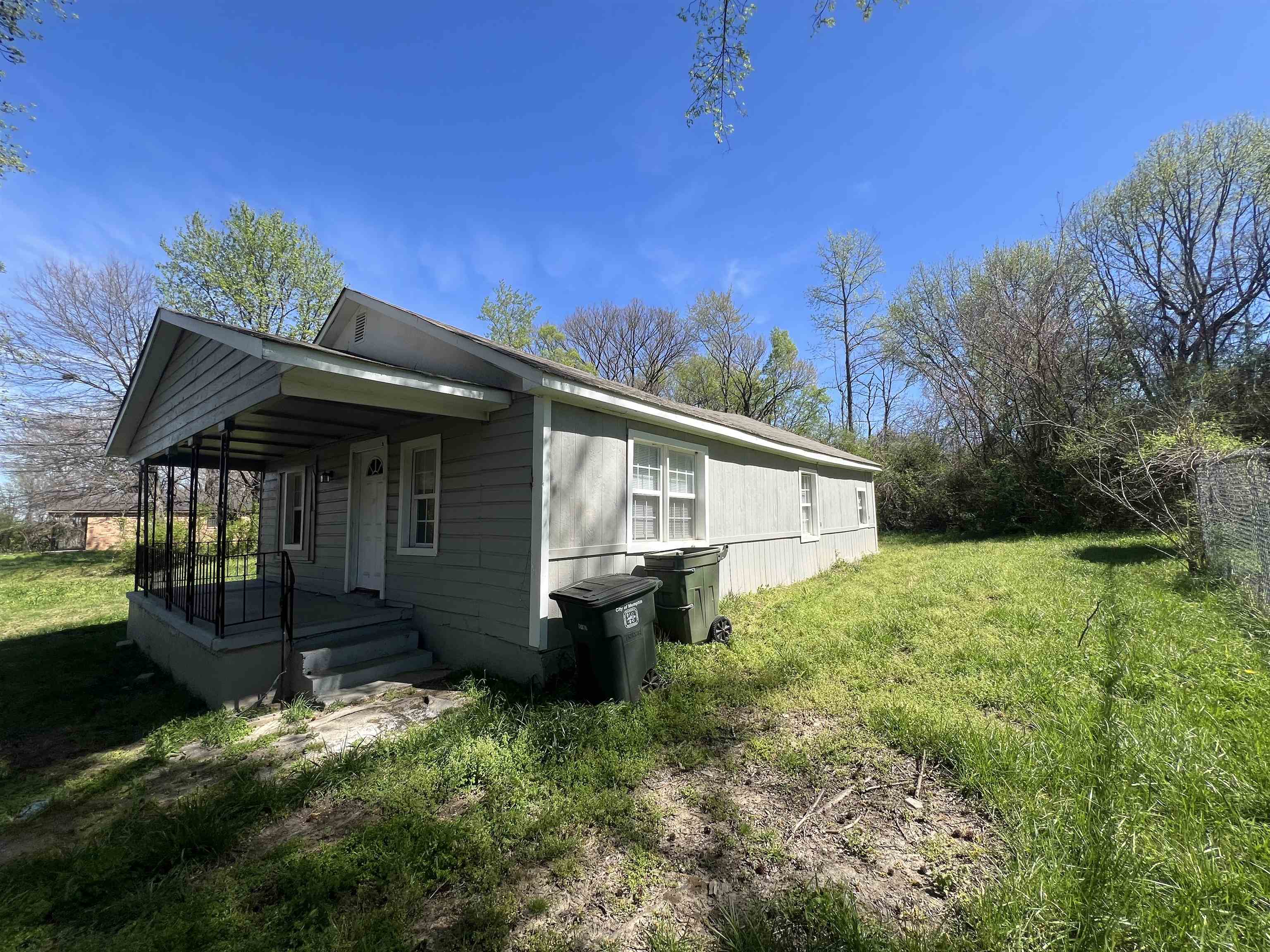 3044 Green Road Memphis, TN 38109 - Photo 13 of 13 View of side of home featuring a yard