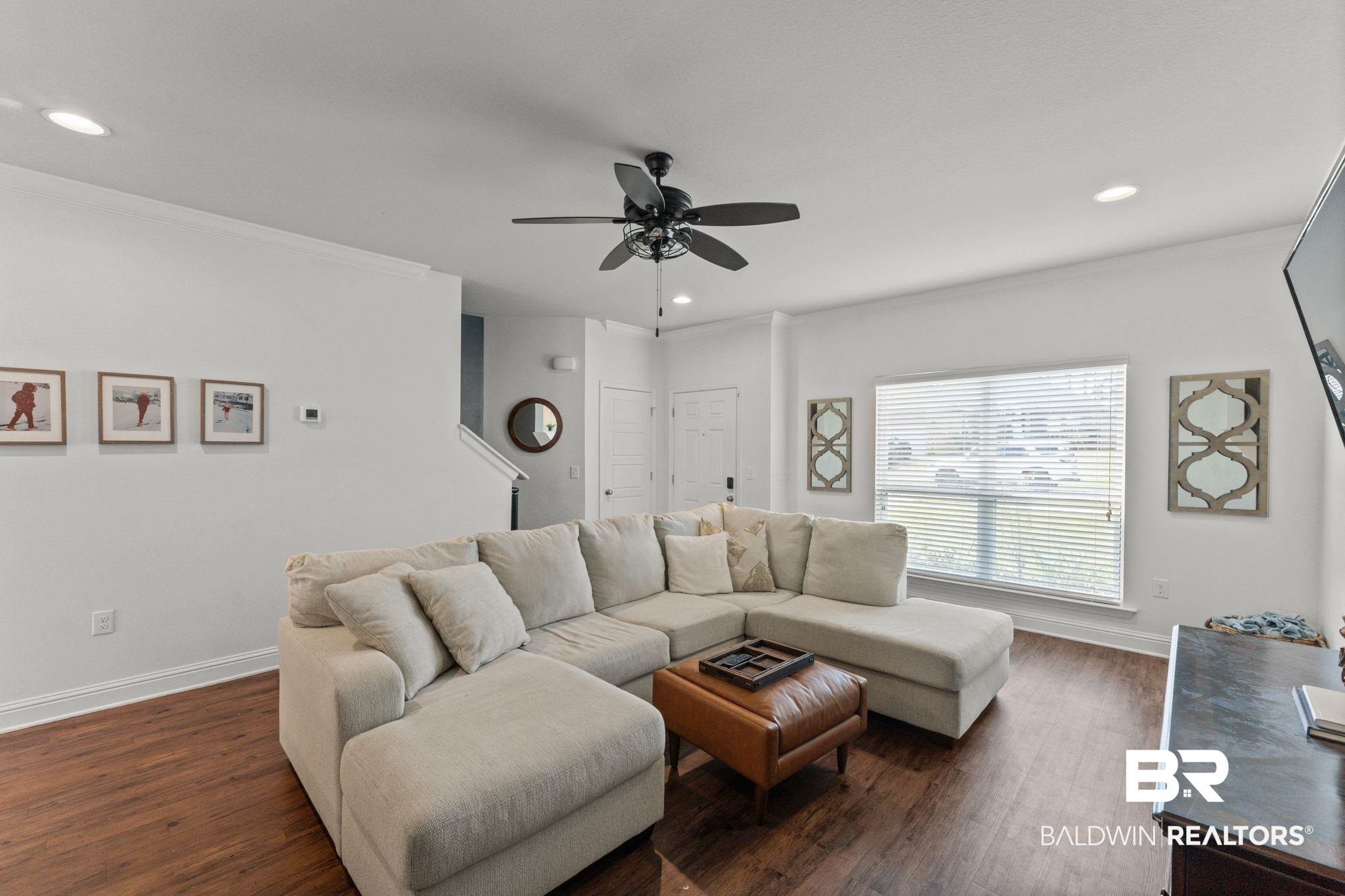 12711 Chickadee Lane Daphne, AL 36527 - Photo 7 of 39 Living area with ornamental molding, recessed lighting, dark wood-style flooring, and ceiling fan