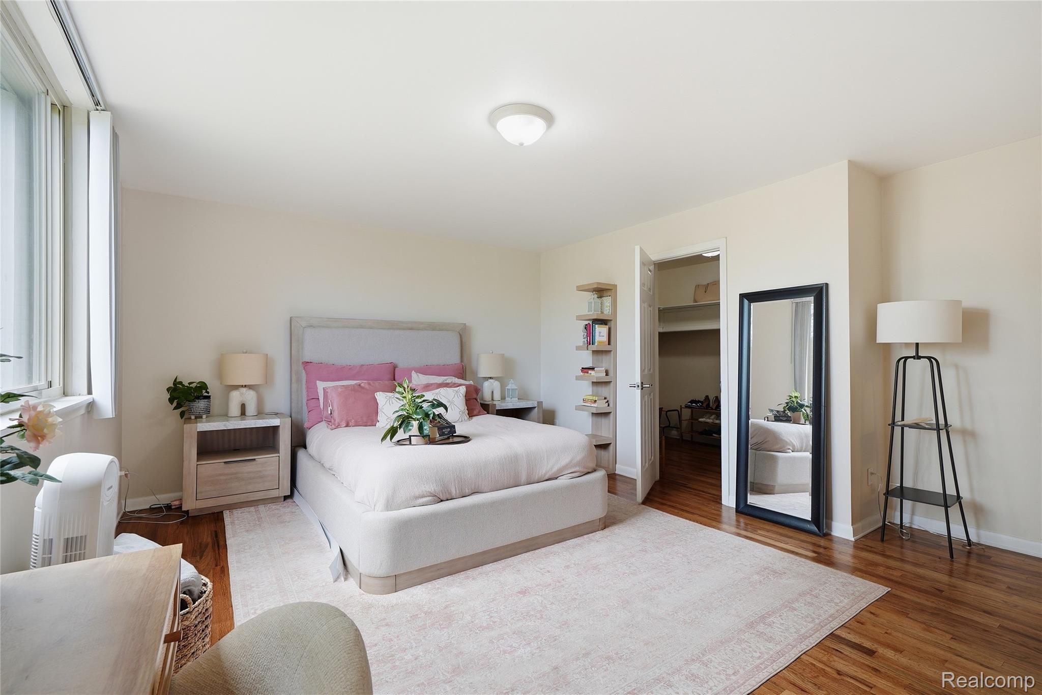 4041 West Maple Road, Unit E203 Bloomfield Hills, MI 48301 - Photo 16 of 25 Bedroom with a spacious closet and wood finished floors