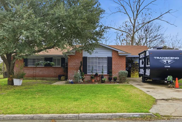 a front view of a house with a yard and sitting area