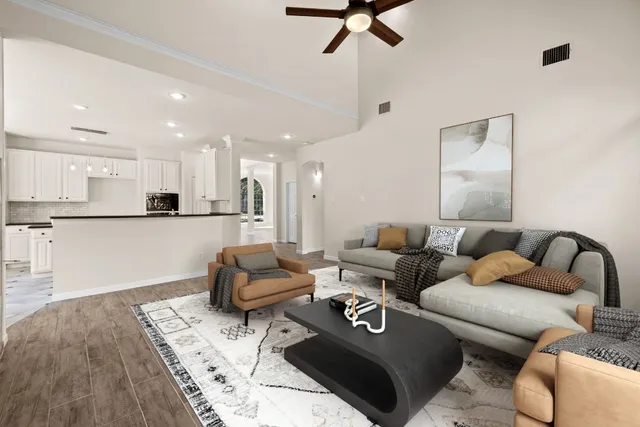 a living room with furniture and kitchen view