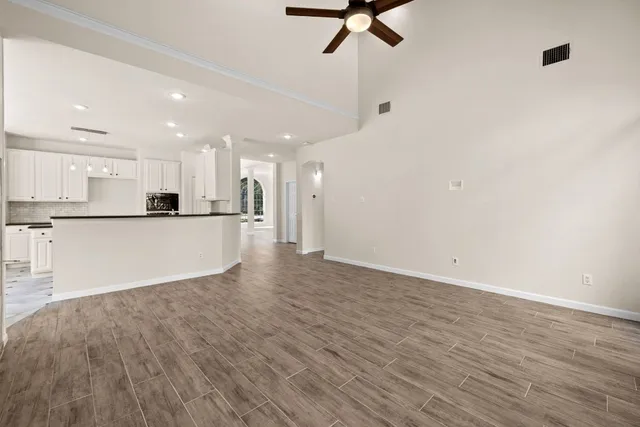 a view of kitchen with stainless steel appliances refrigerator stove top oven and cabinets