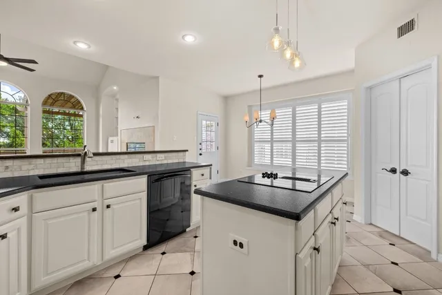 a kitchen that has a sink and a stove in it