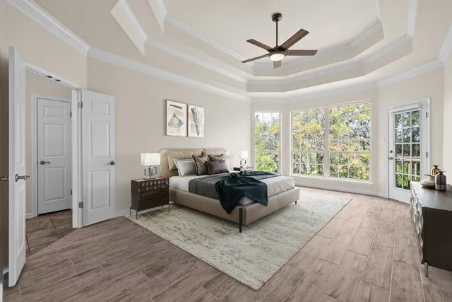 a living room with furniture and a large window with wooden floor
