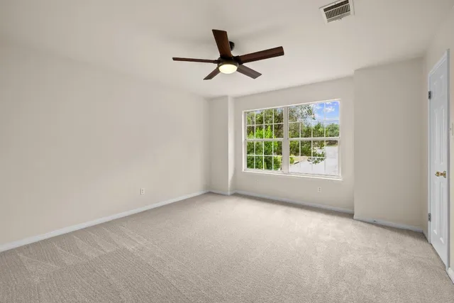 a view of a livingroom with a ceiling fan and window