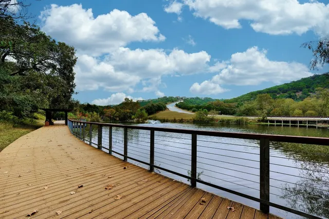 a view of a living room with furniture and floor to ceiling window