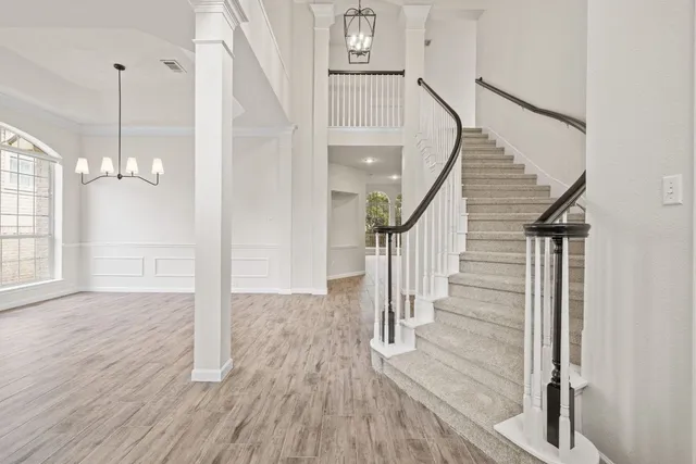 a view of entryway and hall with wooden floor