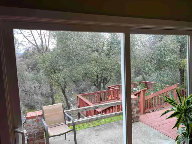 a front view of a house with garden and patio