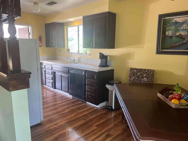 a kitchen with a sink appliances and cabinets