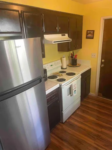 a kitchen with a white stove top oven and sink