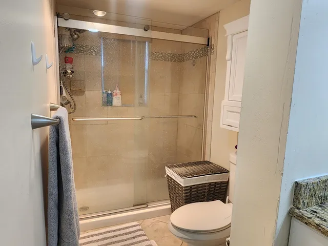 a bathroom with a toilet and a shower
