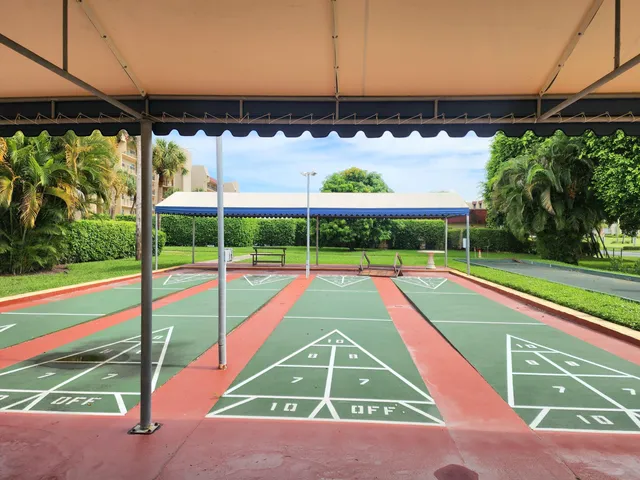 a view of a tennis ground with a small park