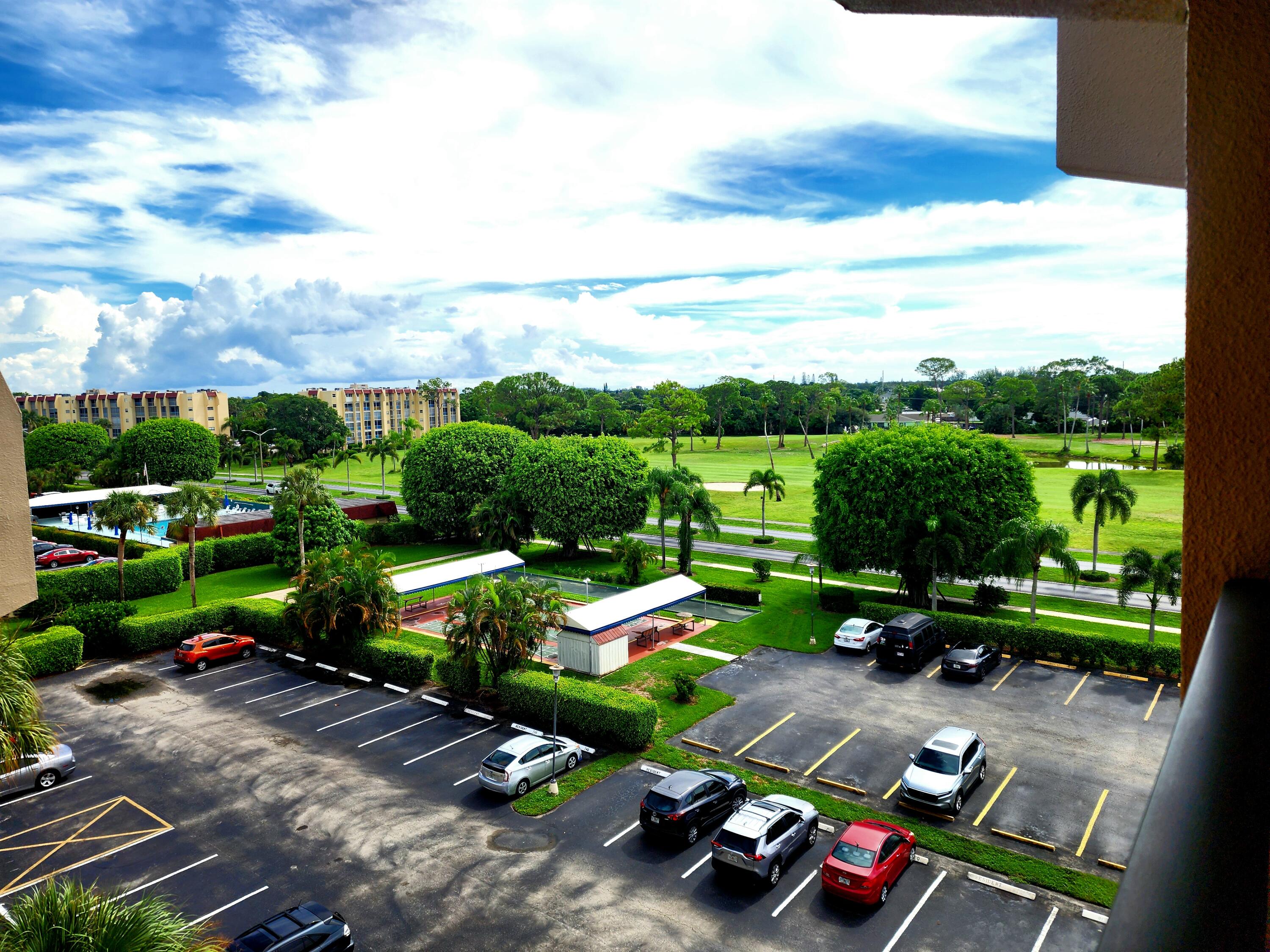3755 Via Poinciana, Unit 607 Lake Worth, FL 33467 - Photo 19 of 19 a green field with lots of potted plants