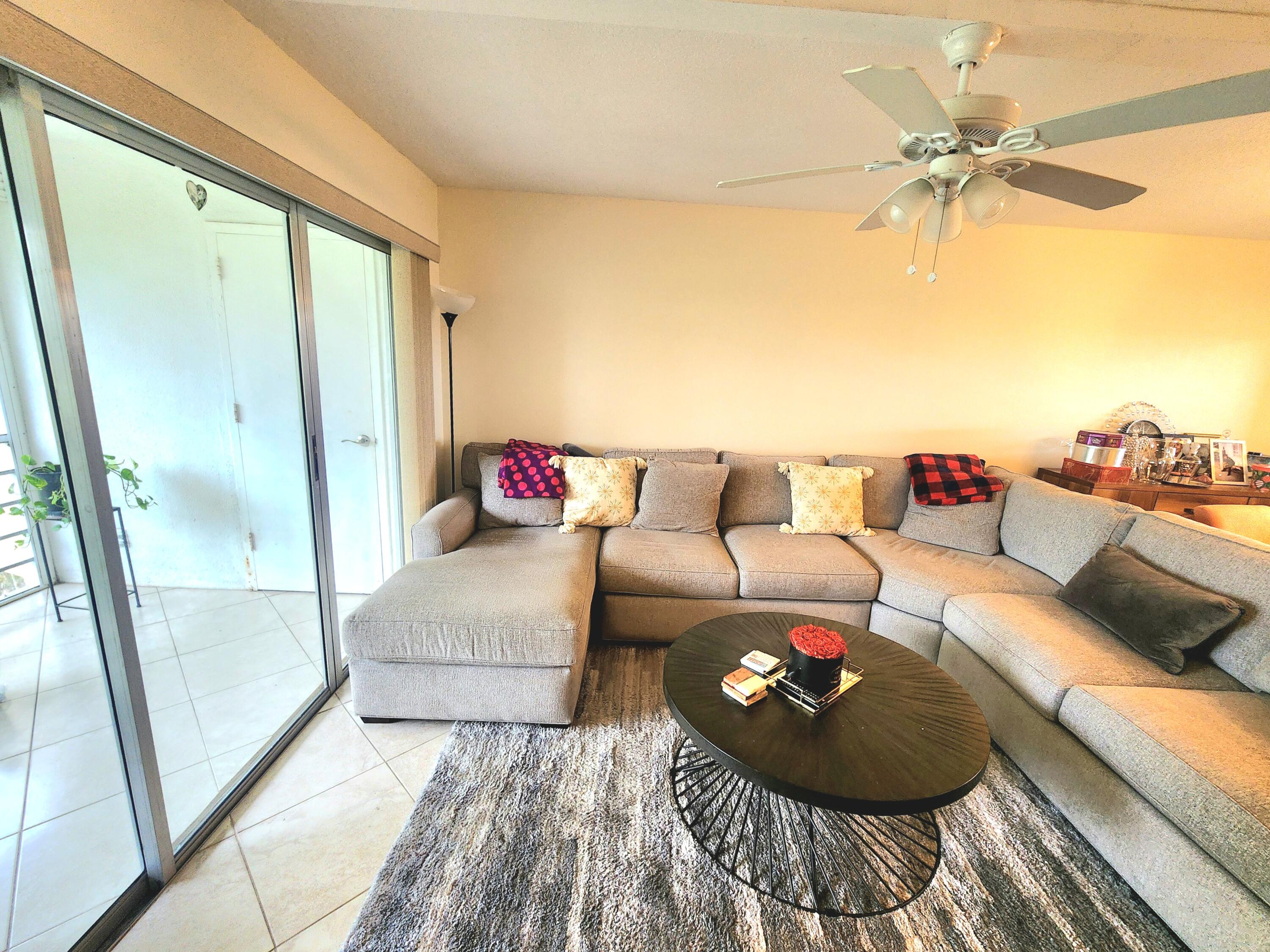 3755 Via Poinciana, Unit 607 Lake Worth, FL 33467 - Photo 2 of 19 a living room with furniture and a rug