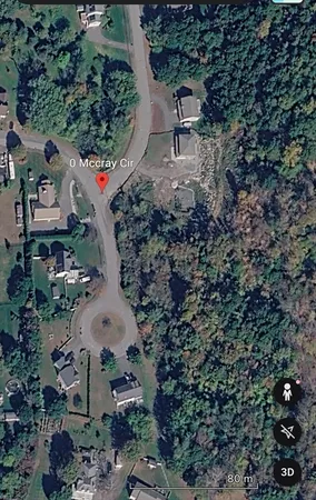 an aerial view of a house with a yard and lake view