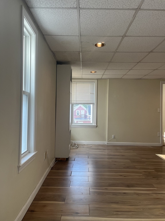 41 Winter Street, Unit 2R Fitchburg, MA 01420 - Photo 12 of 13 a view of an empty room with wooden floor and a window