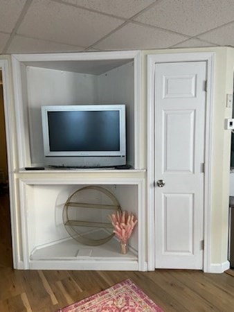 41 Winter Street, Unit 2R Fitchburg, MA 01420 - Photo 9 of 13 a living room with a flat screen tv and a fireplace