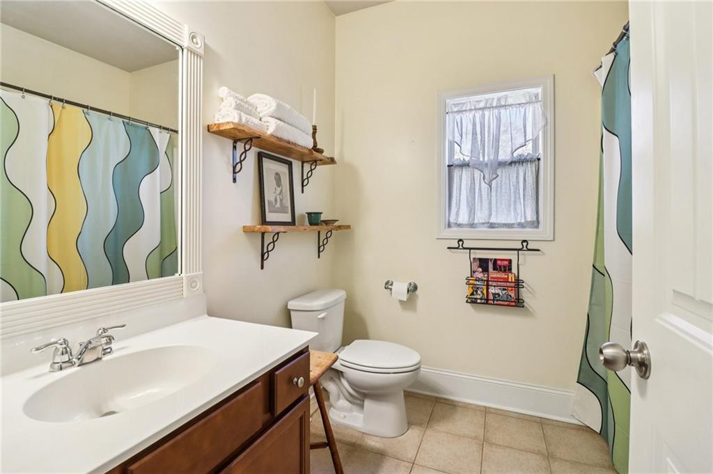 2007 Eagles Ridge Waleska, GA 30183 - Photo 16 of 45 a bathroom with a sink a toilet and shower curtain