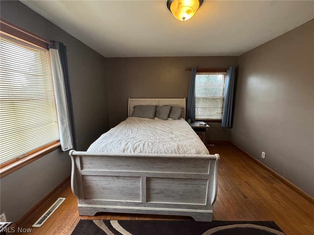 3828 Lake Road West Ashtabula, OH 44004 - Photo 10 of 29 Bedroom with hardwood floors and natural woodwork
