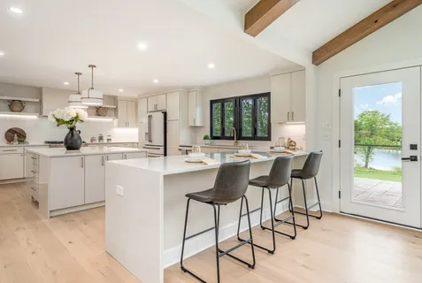 a kitchen with stainless steel appliances kitchen island granite countertop a sink and cabinets