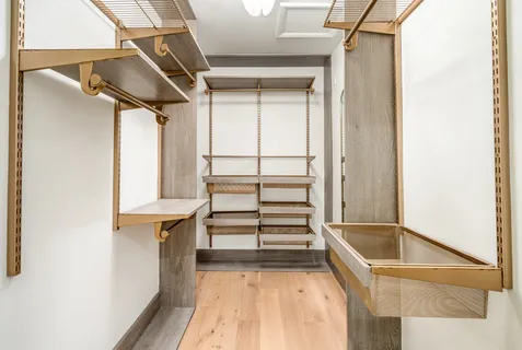 a view of walk in closet with empty racks