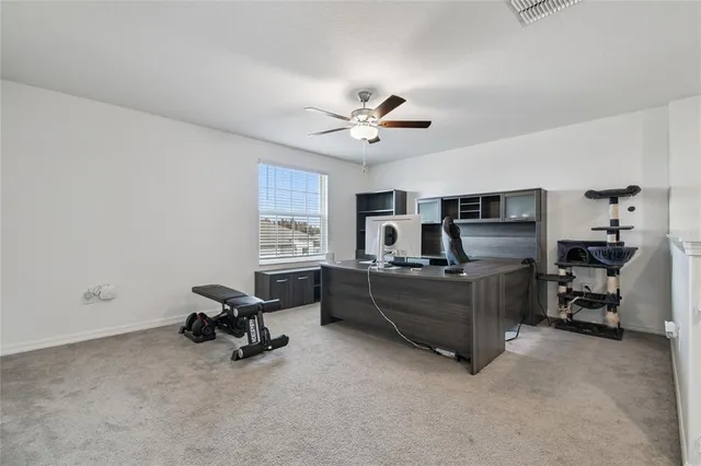 an empty room with a ceiling fan and a ceiling fan