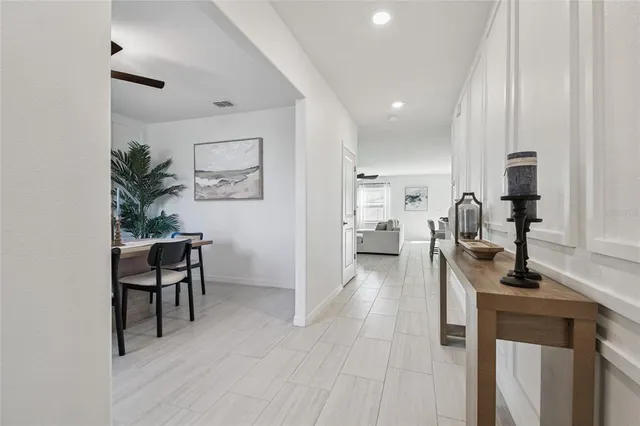 a kitchen with a sink a refrigerator and a stove top oven with wooden floor