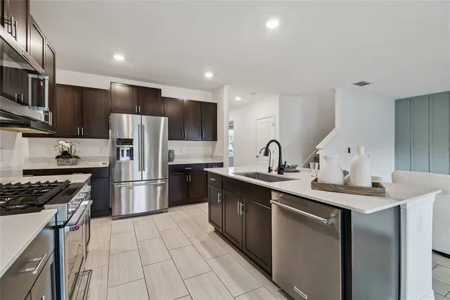 a spacious bedroom with a bed and dresser