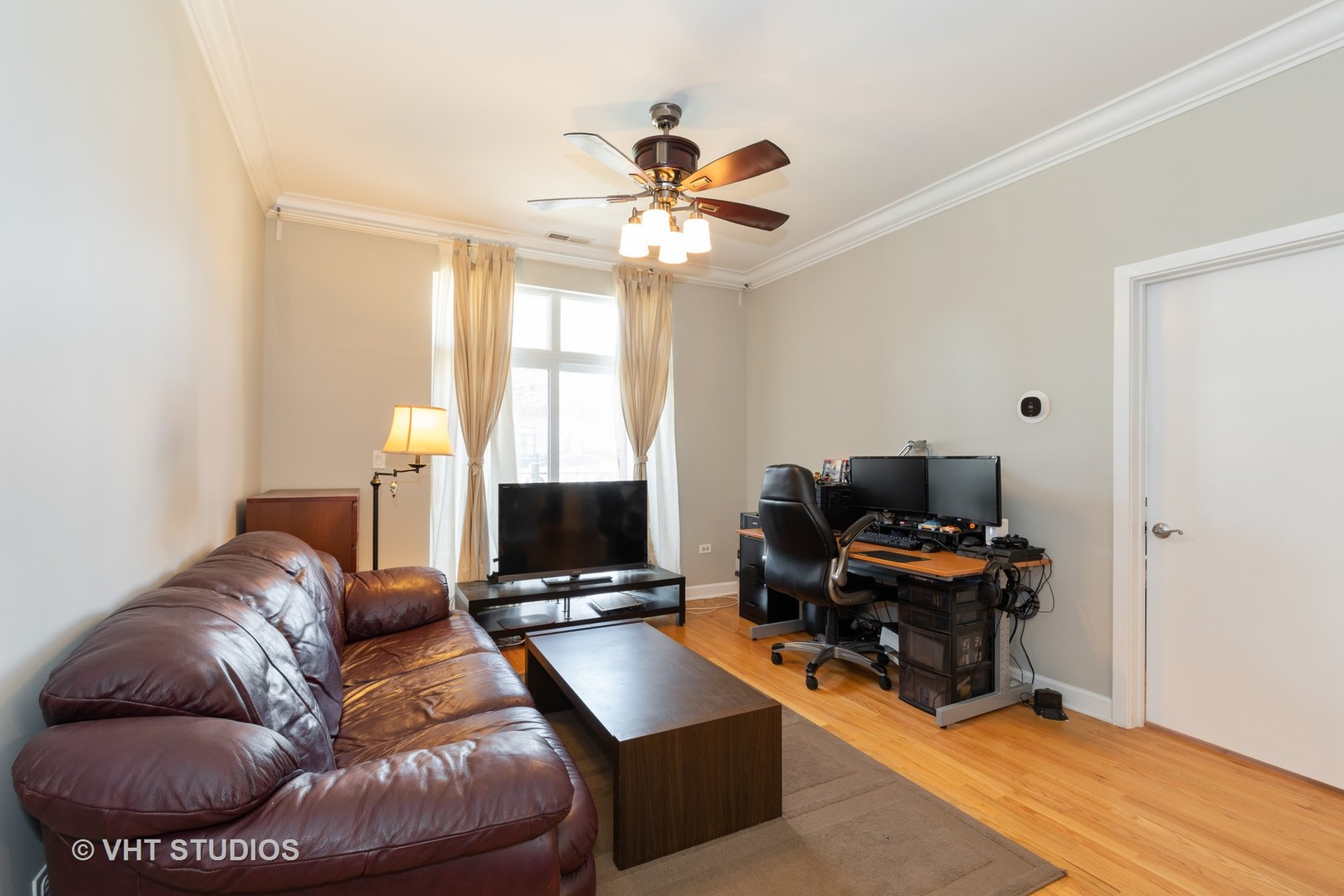 756 West 14th Street, Unit 102 Chicago, IL 60607 - Photo 3 of 10 a living room with furniture a ceiling fan and a rug