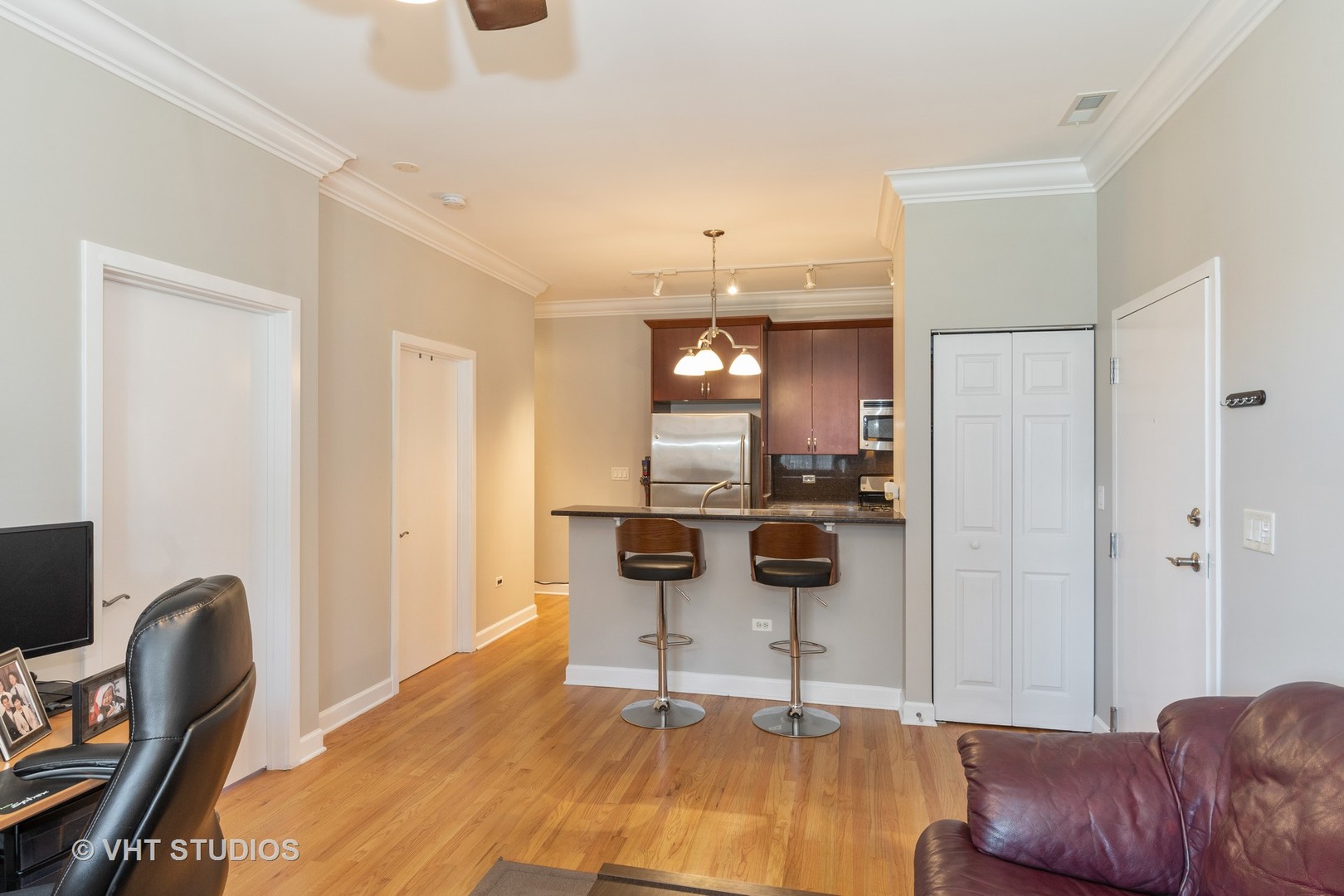 756 West 14th Street, Unit 102 Chicago, IL 60607 - Photo 4 of 10 a living room with furniture a kitchen view and a dining table