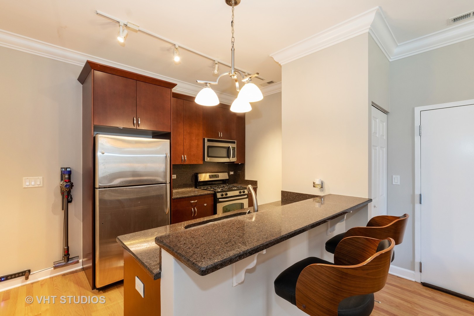 756 West 14th Street, Unit 102 Chicago, IL 60607 - Photo 5 of 10 a kitchen with cabinets and stainless steel appliances