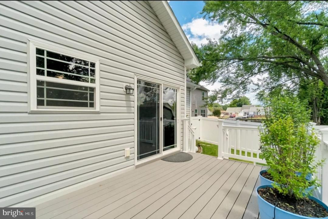 Sunny deck with charming greenery.