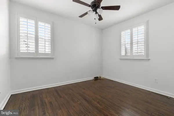 a view of a room with wooden floor and windows