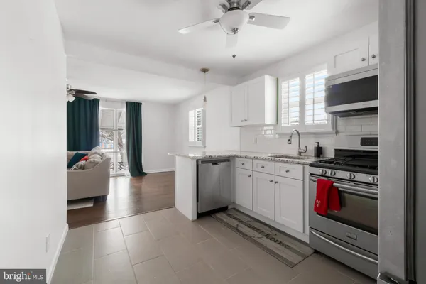 a kitchen with stainless steel appliances granite countertop a stove and a refrigerator