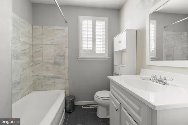 a bathroom with a sink toilet and bathtub