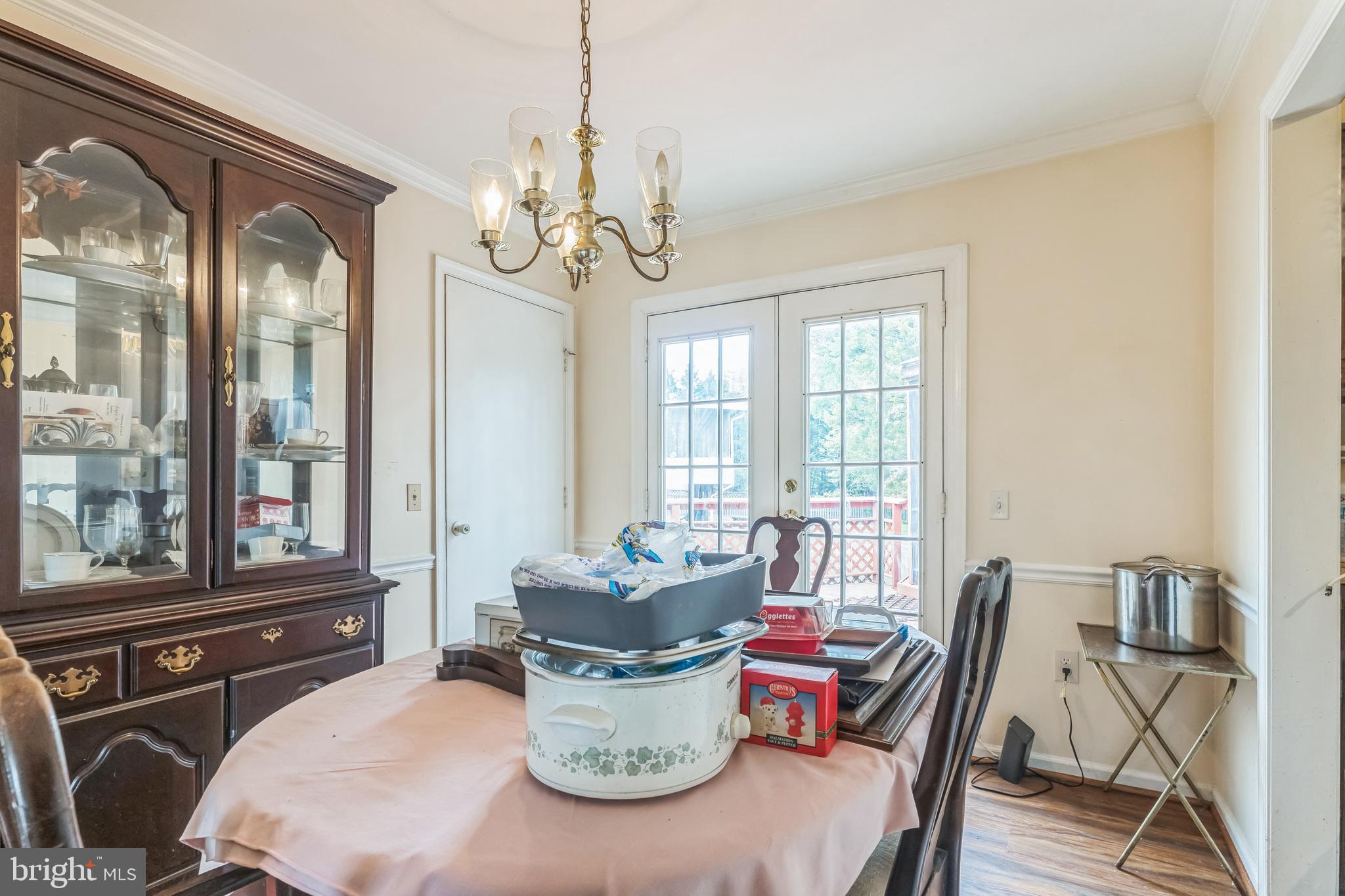 10200 Balsamwood Drive Laurel, MD 20708 - Photo 5 of 11 a dining room with furniture a chandelier and wooden floor