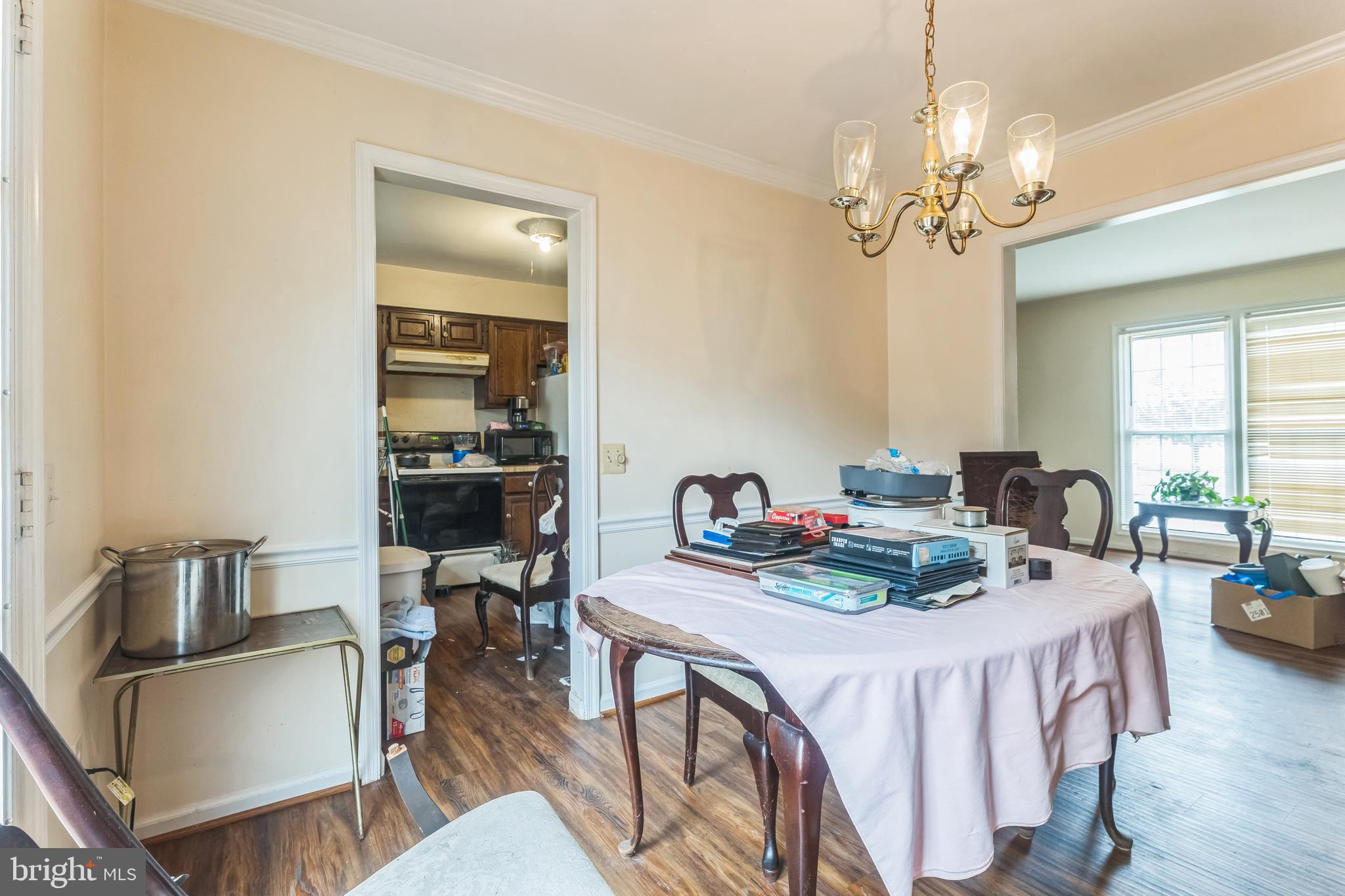 10200 Balsamwood Drive Laurel, MD 20708 - Photo 6 of 11 a view of a dining room with furniture a chandelier and wooden floor