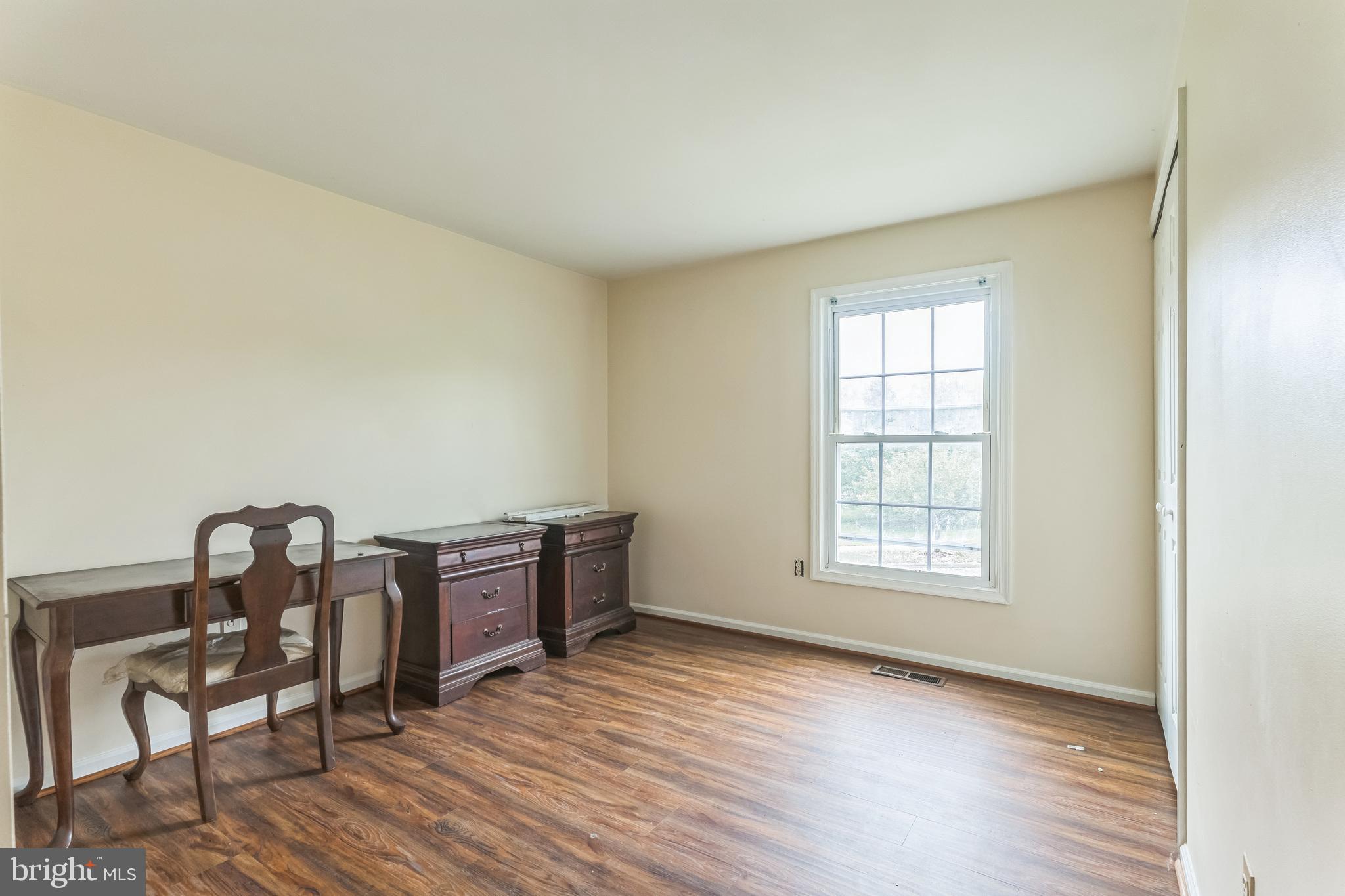 10200 Balsamwood Drive Laurel, MD 20708 - Photo 9 of 11 an empty room with furniture and wooden floor