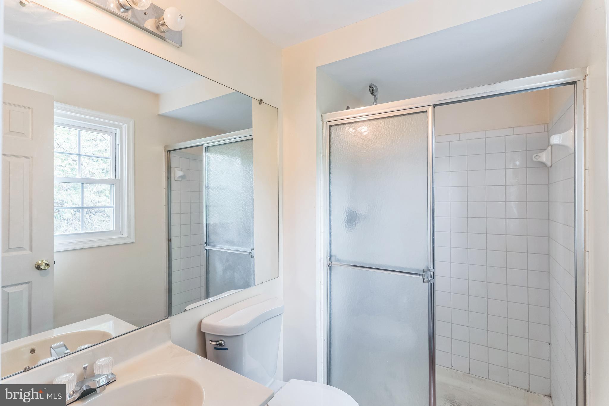 10200 Balsamwood Drive Laurel, MD 20708 - Photo 10 of 11 a bathroom with a toilet shower vanity and a sink