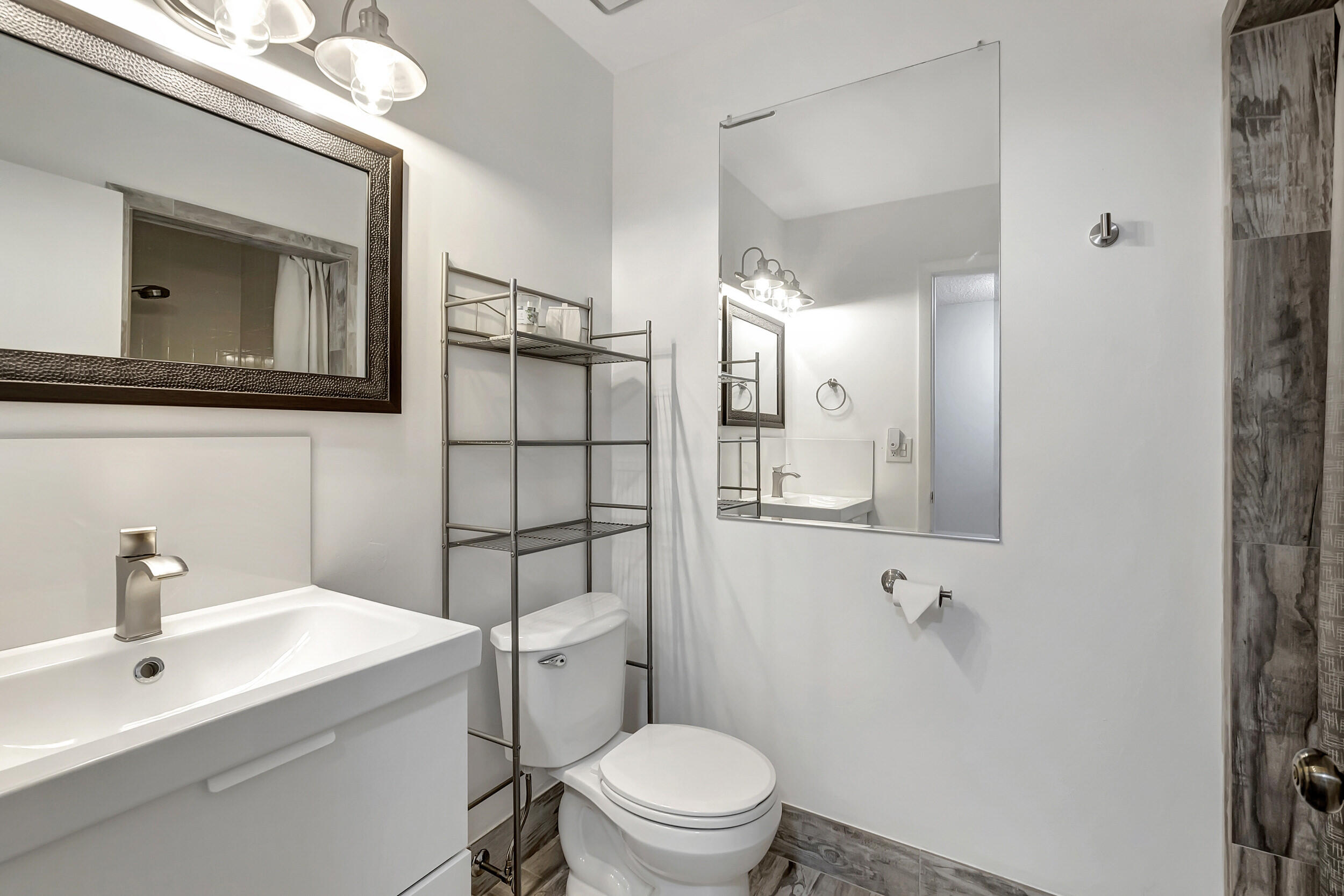 14040 Nesting Way, Unit B Delray Beach, FL 33484 - Photo 17 of 26 a bathroom with a toilet a sink and mirror